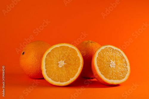 Fresh and juicy orange photographed on a background of orange