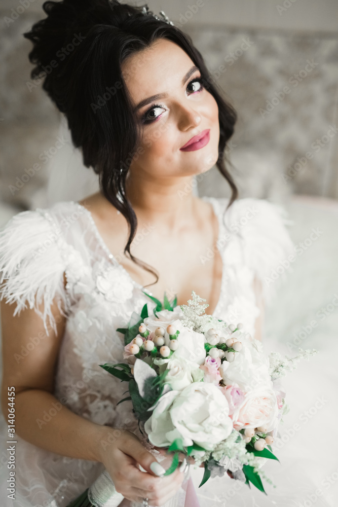 Portrait of stunning bride with long hair posing with great bouquet Portrait of stunning bride with long hair posing with great bouquet