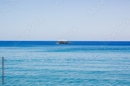 idyllic summer time vacation resort destination place on Red sea waters environment near south coast of Israel wooden bungalow horizon background wallpaper copy space for your text here