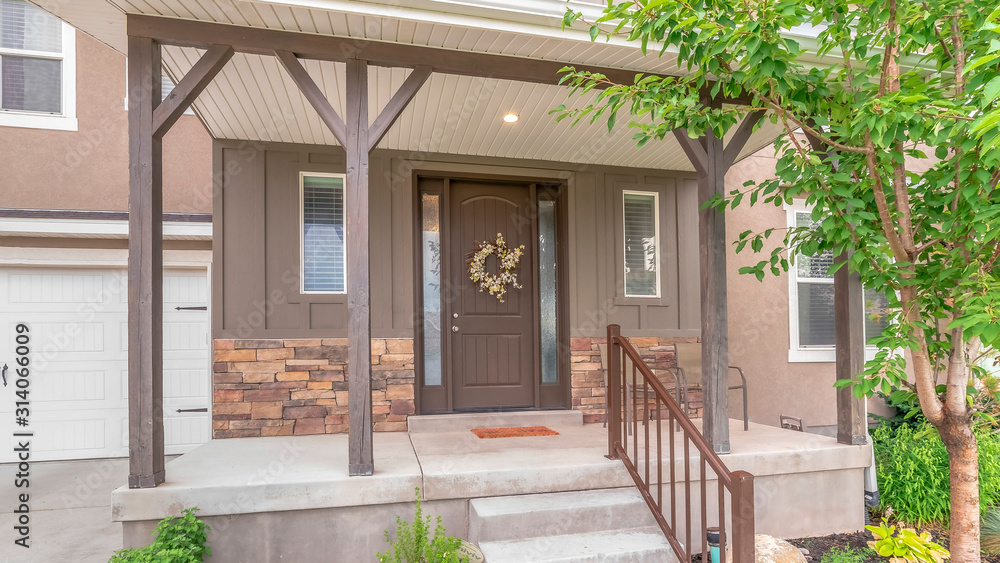 Fototapeta premium Pano frame Home with stairs leading to porch and door flanked with sidelights and windows