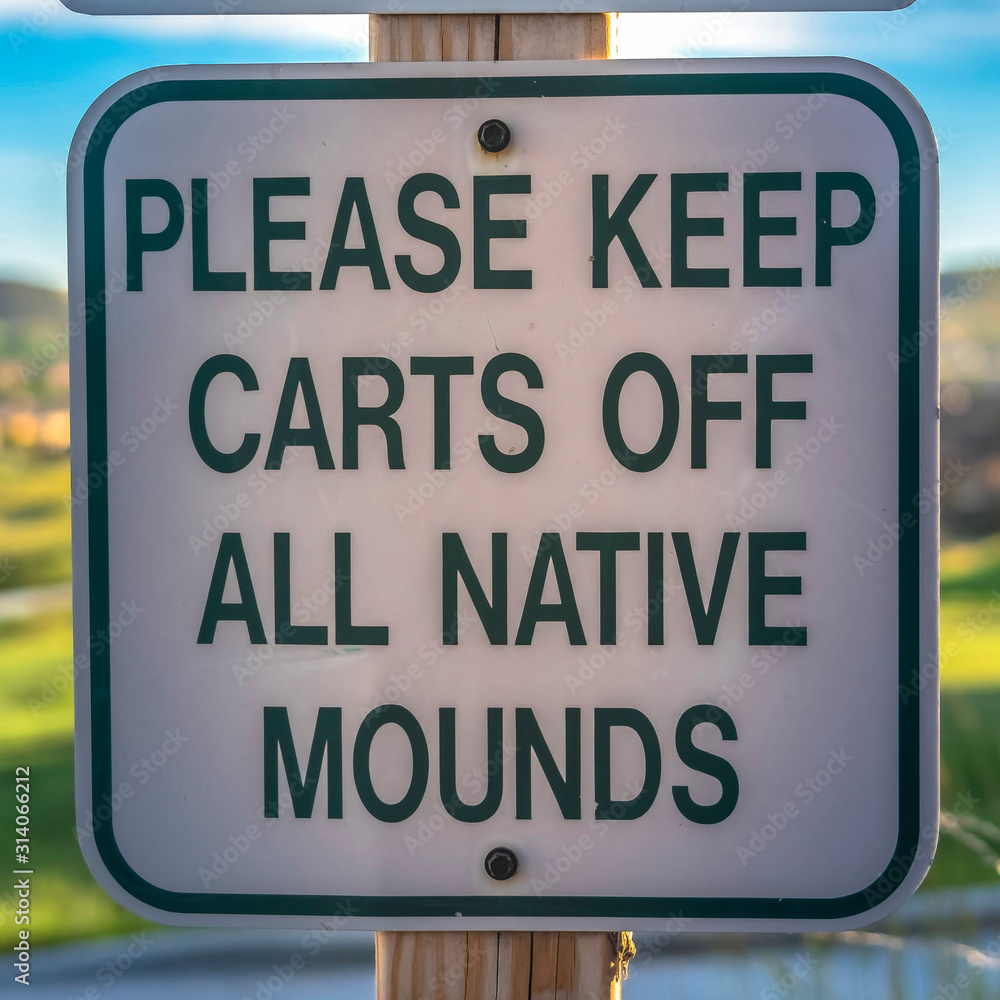 Square frame Close up of golf course sign that reads Please Keep Carts Off All Native Mounds