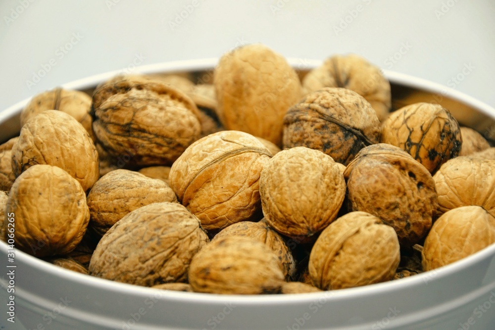 Whole walnuts in a bowl. Closeup Whole walnuts in a bowl. Closeup