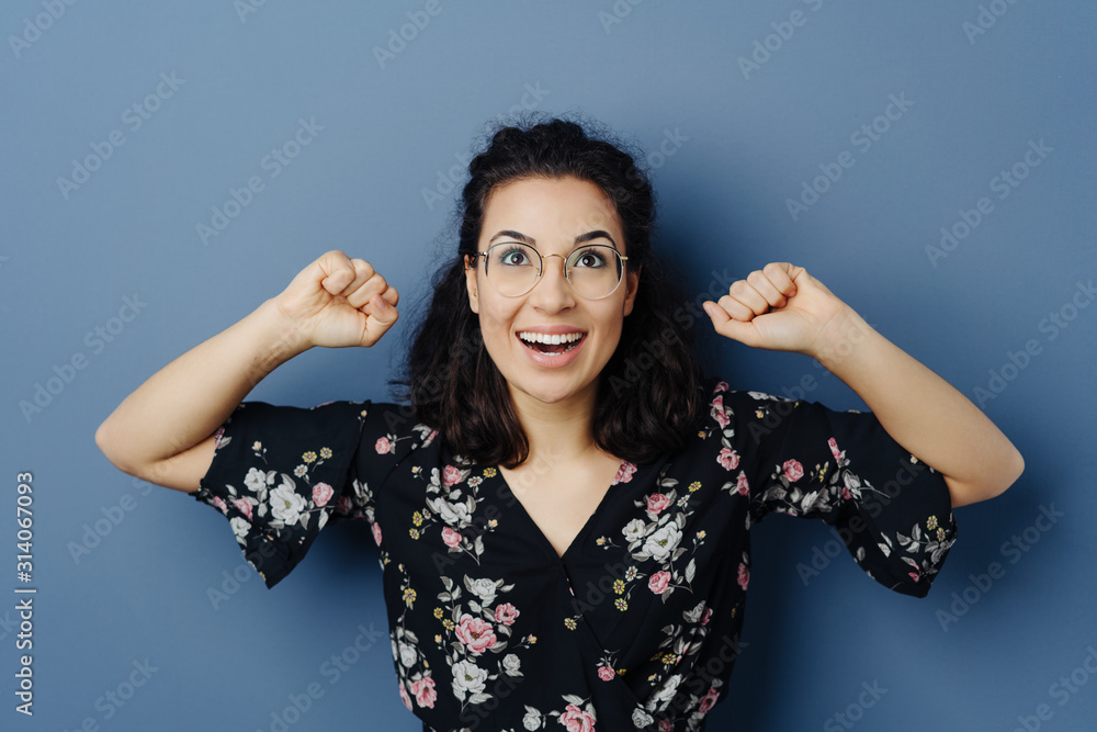 Excited exultant young woman cheering Excited exultant young woman cheering