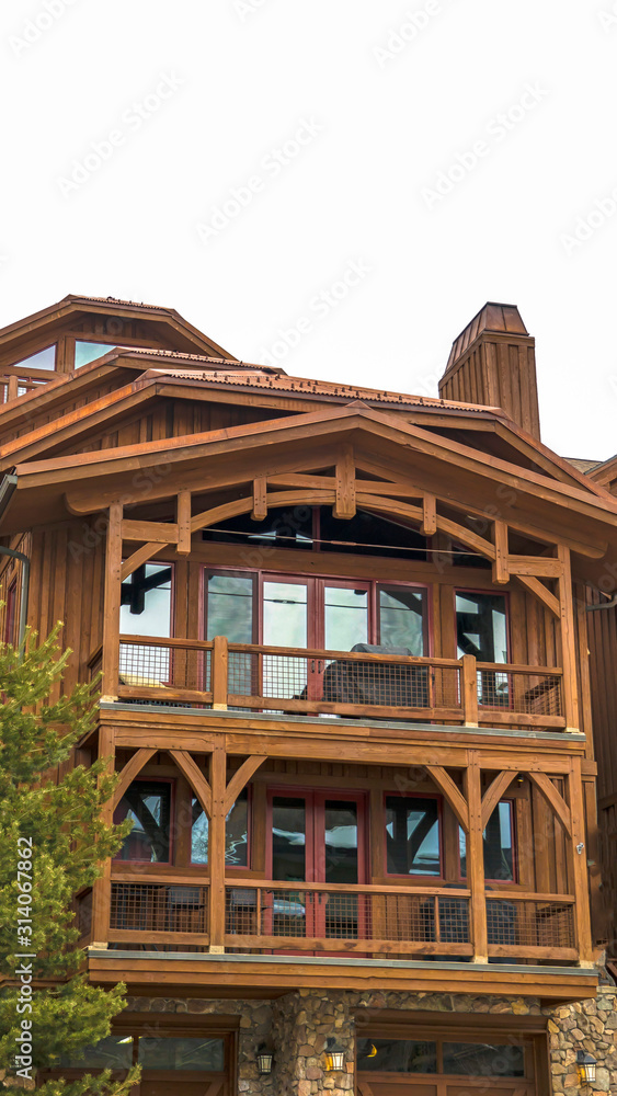 Vertical frame Exterior of cabin in Park City Utah with brown wood exterior wall and balconies Vertical frame Exterior of cabin in Park City Utah with brown wood exterior wall and balconies