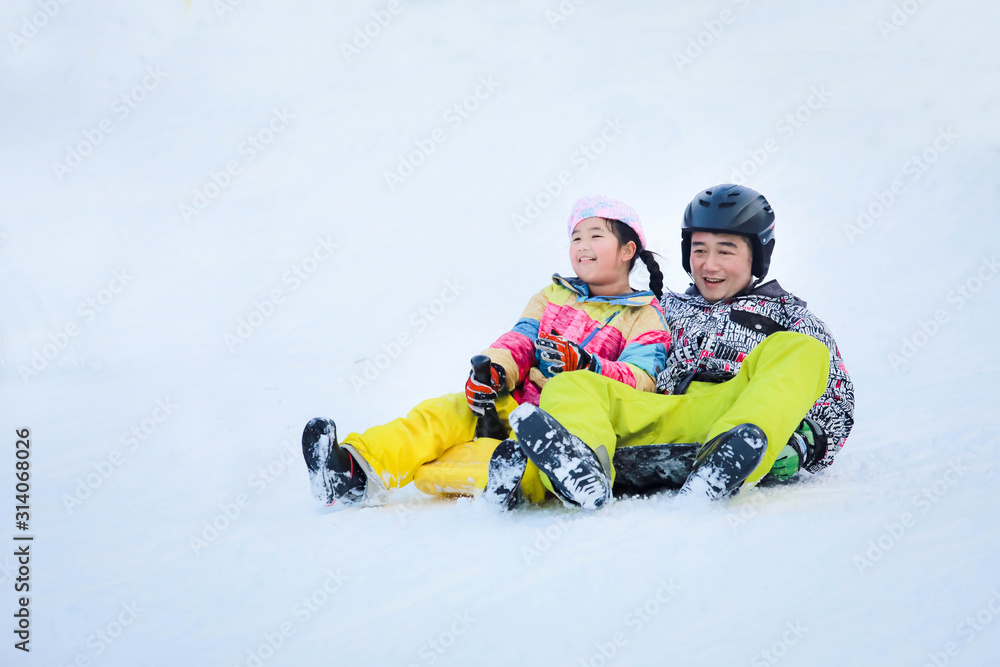 Father and daughter are happy on a snowy day Father and daughter are happy on a snowy day