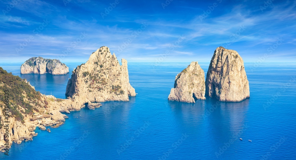 Famous Faraglioni Rocks near Capri Island, Italy. Beautiful paradise landscape with azure sea in summer sunny day.