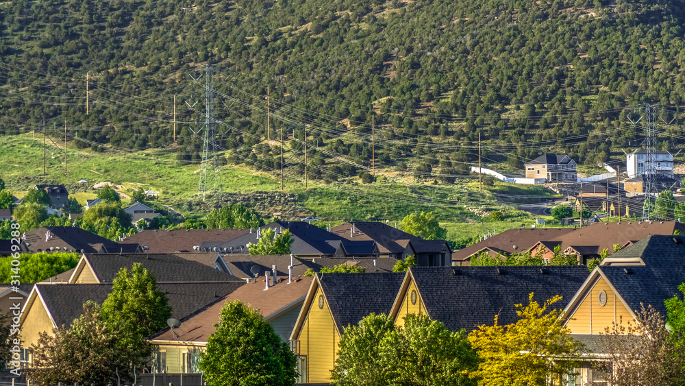 Pano Sunny view of houses on a residential area with mountain and blue sky background