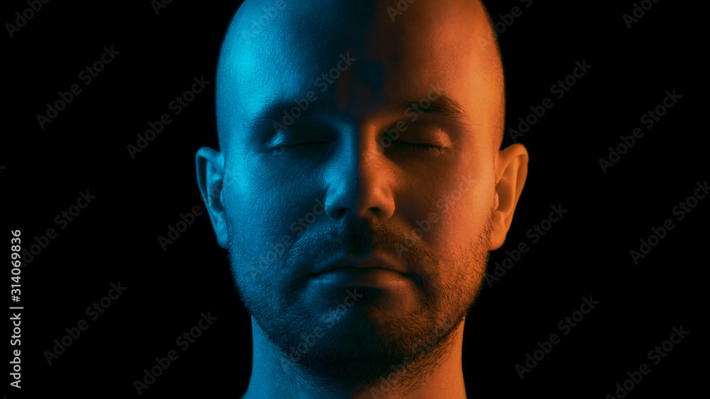 A man with closed eyes is meditating. Dual color theme. Black background A man with closed eyes is meditating. Dual color theme. Black background