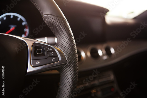 Canvas Print Control buttons on the steering wheel of a car