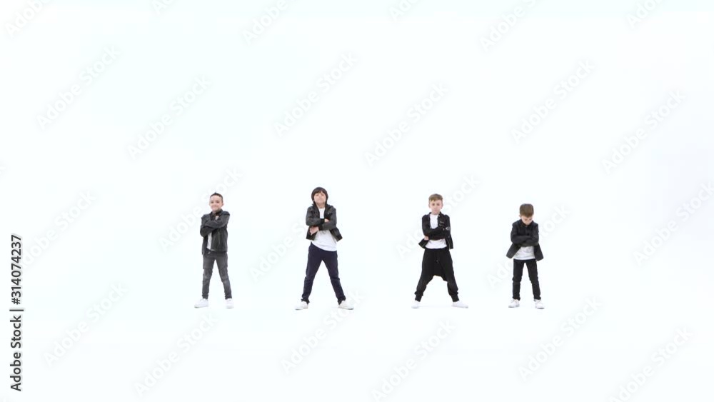 Little boys are dancing a modern dance on the white background in black leather jackets and jeans Little boys are dancing a modern dance on the white background in black leather jackets and jeans