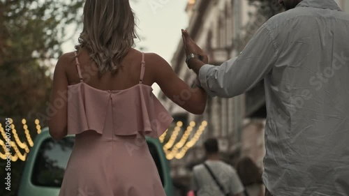 Wallpaper Mural Back view young nice couple man and woman are walking by street outdoors in summer holding their hands Torontodigital.ca