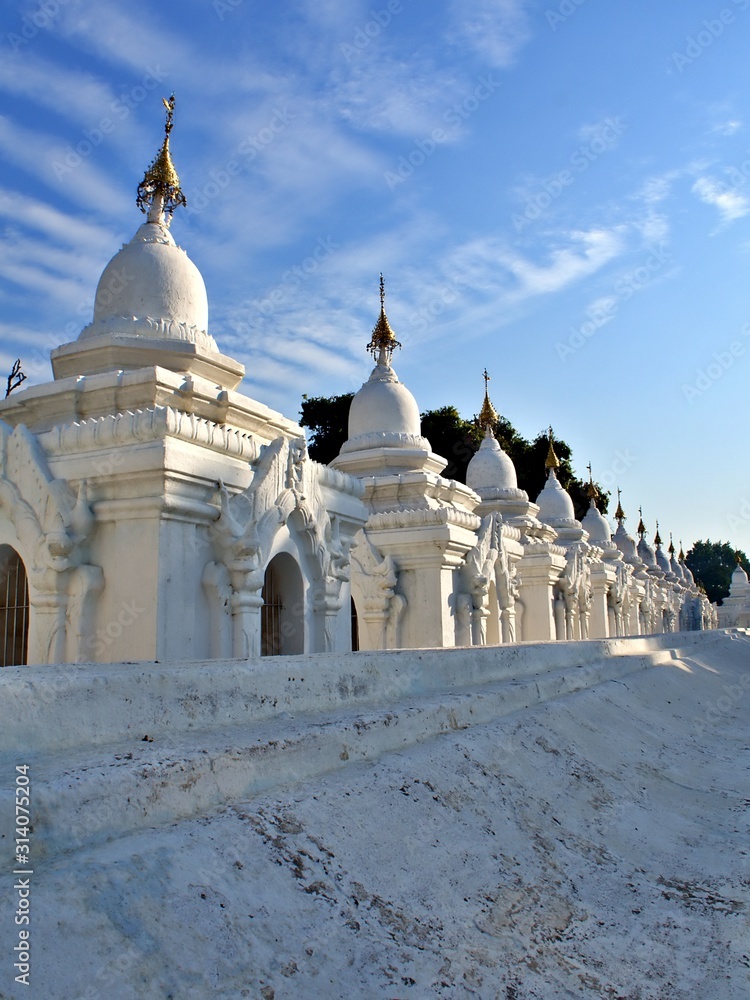 Fototapeta premium The pagoda of Kuthodaw Pagoda with wave of cloud in Mandalay, Myanamr