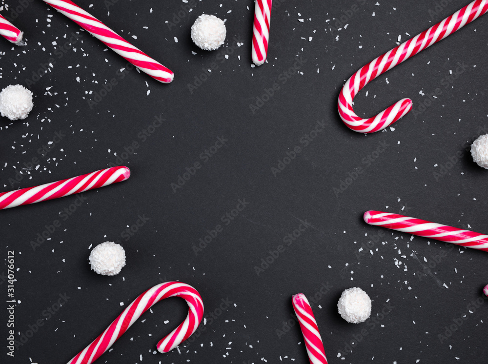 Candy canes set in a circle shapers on a black background with white ...