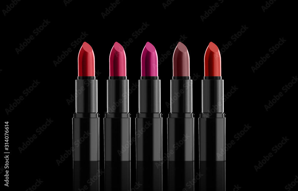 Obraz premium A few bright lipsticks, sparkles on a dark background. Horizontally