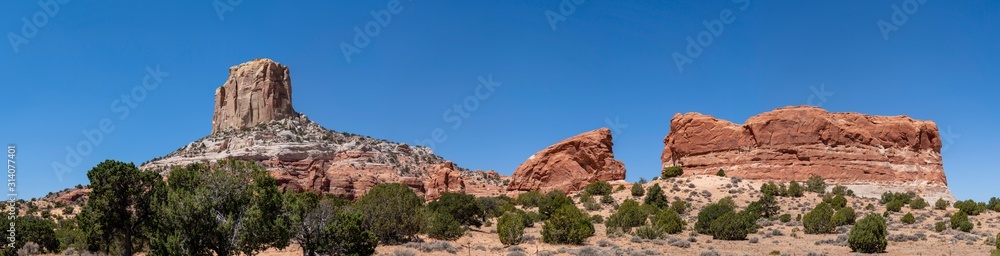 Square Butte landscape on a sunny day with mountains an trees, arizona