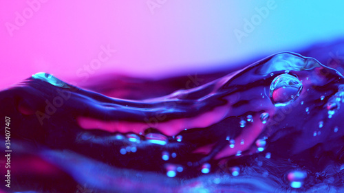 Detail of water waves in neon lights photo