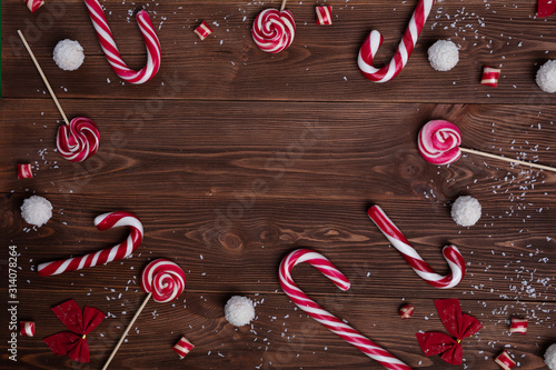 Christmas postcard. Celebration invitation with sweets on a wooden background. Сhristmas spirit. New Year concept. photo