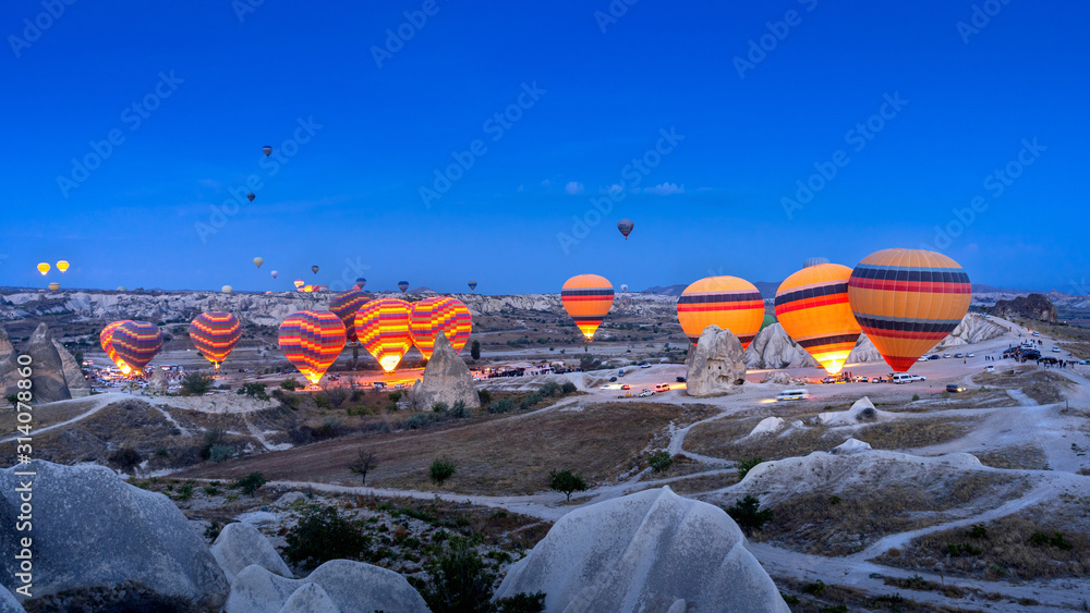 Vibrant colorful hot air balloons in Cappadocia, Turkey. - obrazy, fototapety, plakaty 