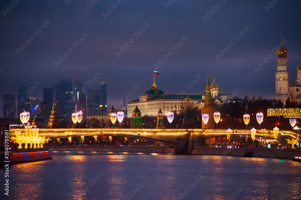 Moscow, Russia - January 03, 2020:   View of the Moscow Kremlin and the Moskva river in the evening with Christmas illumination.