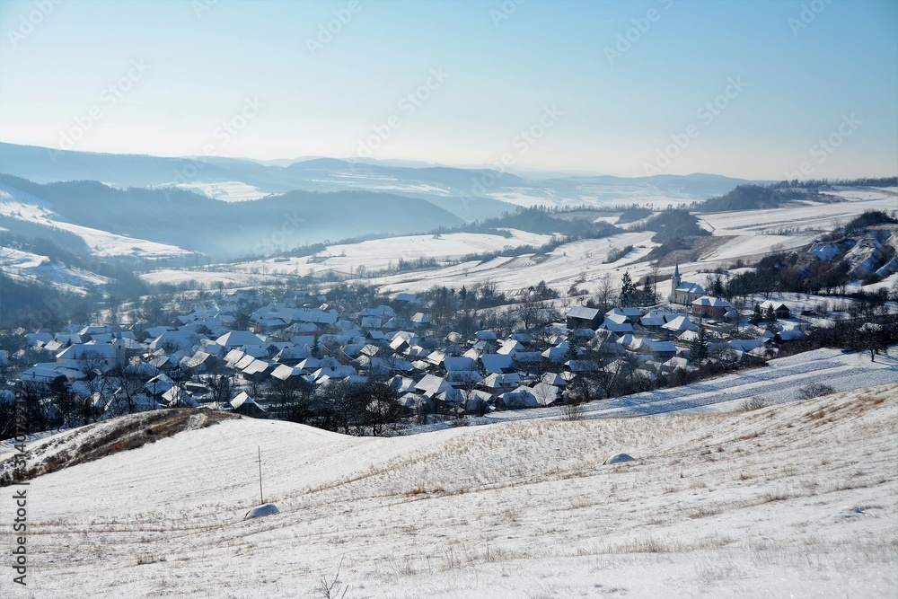 a village between hills in winter