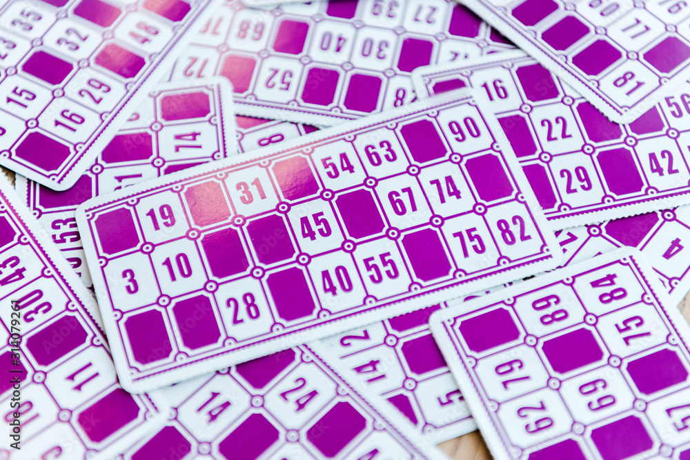 top view of purple lottery tickets with numbers on surface top view of purple lottery tickets with numbers on surface