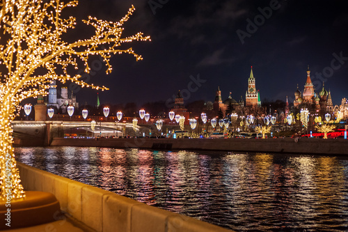 Moscow, Russia - January 03, 2020:   View of the Moscow Kremlin, Moscow river and Christmas decoration city at night.