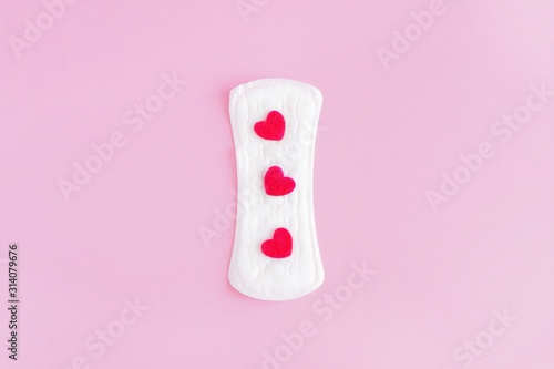 Sanitary pad on a pink background. An alternative choice of feminine hygiene products. Menstrual mothly cycle, means of protection. Top view, flat lay, copy space for text.