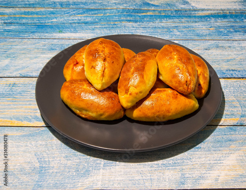 Pies with stewed cabbage and carrots baked in the oven