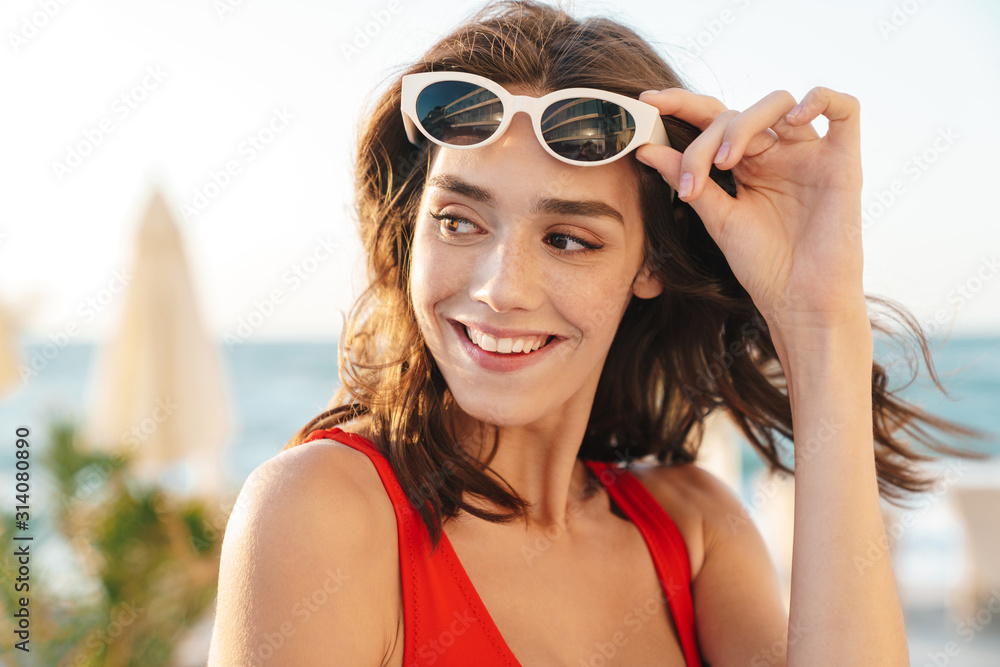Photo closeup of beautiful happy woman smiling and looking aside Photo closeup of beautiful happy woman smiling and looking aside