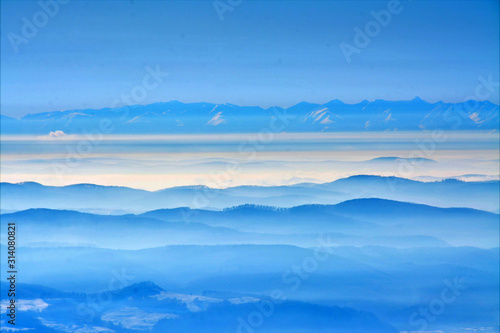the peaks of the mountains seen through the fog