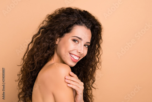 Close up side profile photo beautiful amazing she her lady hiding naked breast chest smearing lotion soft body ideal brilliant appearance toothy mouth wear no clothes isolated beige pastel background