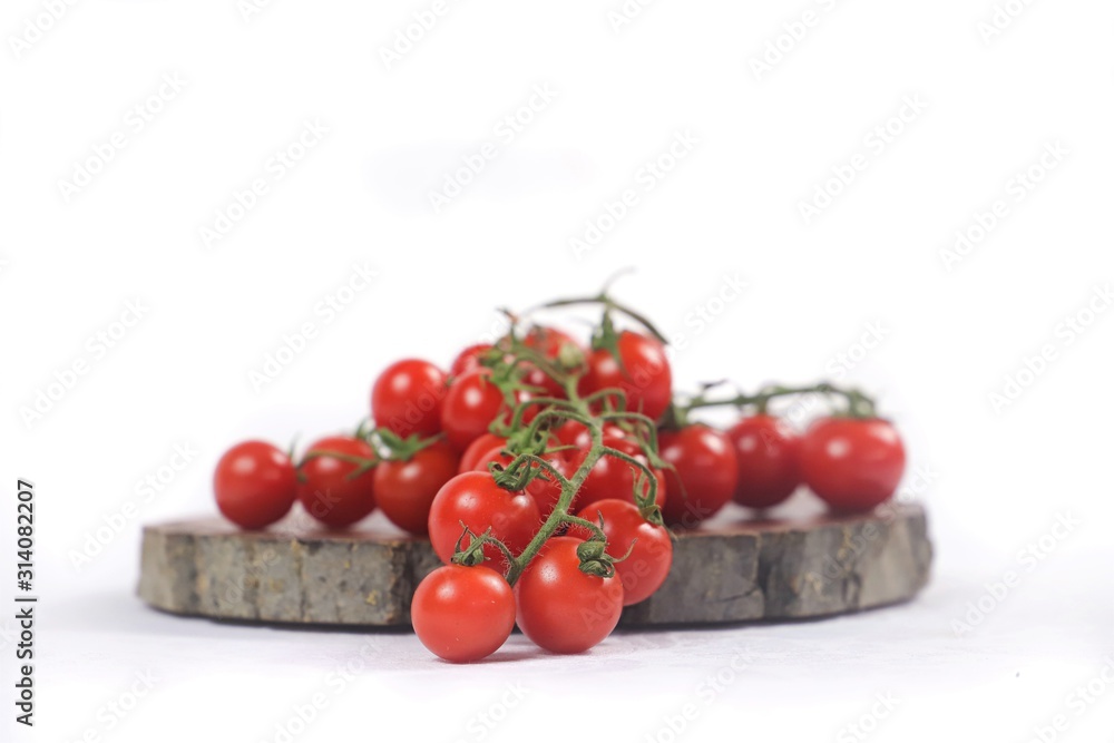 vine tomatoes on wooden cutting board with white background vine tomatoes on wooden cutting board with white background