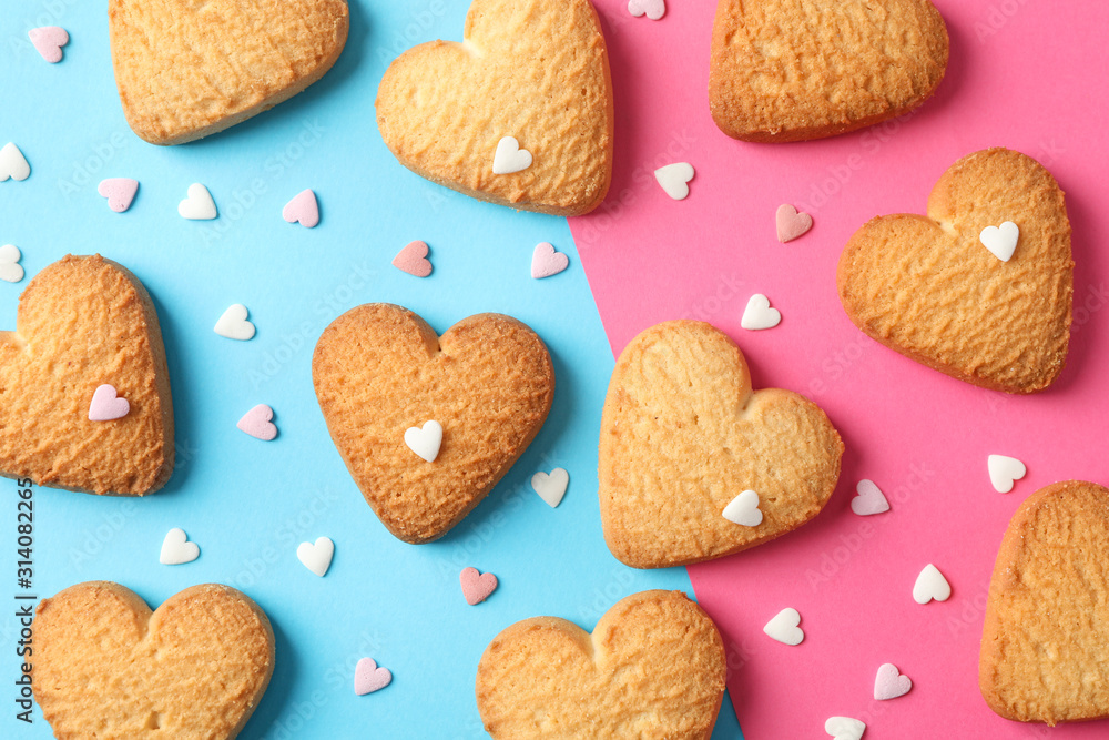 Heart shaped cookies on color background with hearts, top view Heart shaped cookies on color background with hearts, top view