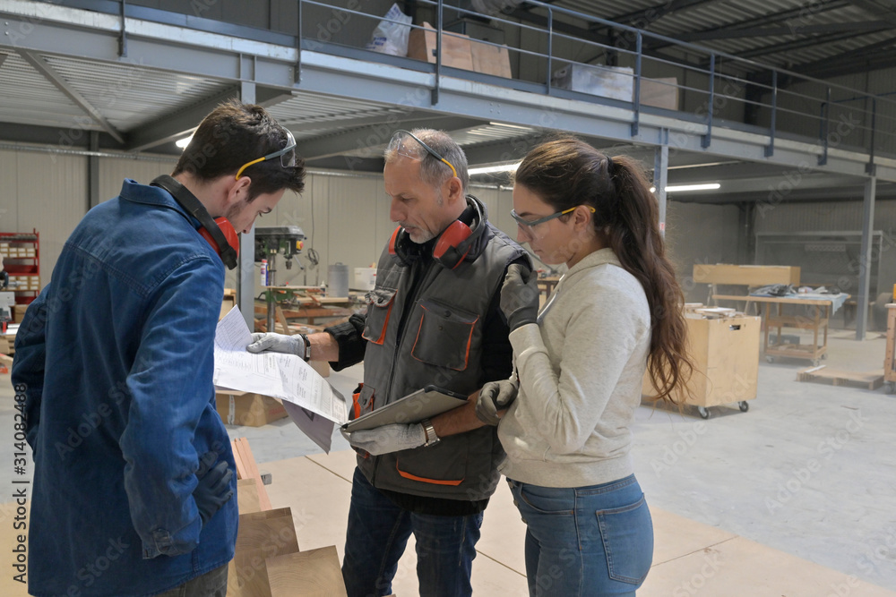 Young people in job training in carpentry workshop Young people in job training in carpentry workshop