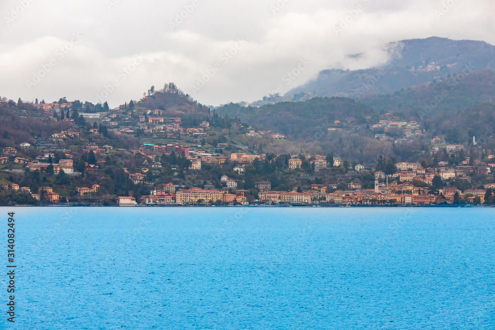 Evening view city Bellagio and Varenna Como water lake Italy blue sky mountain