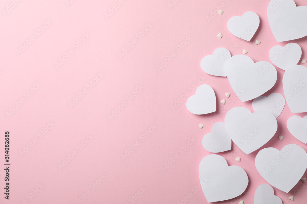 Frame of hearts on pink background, space for text