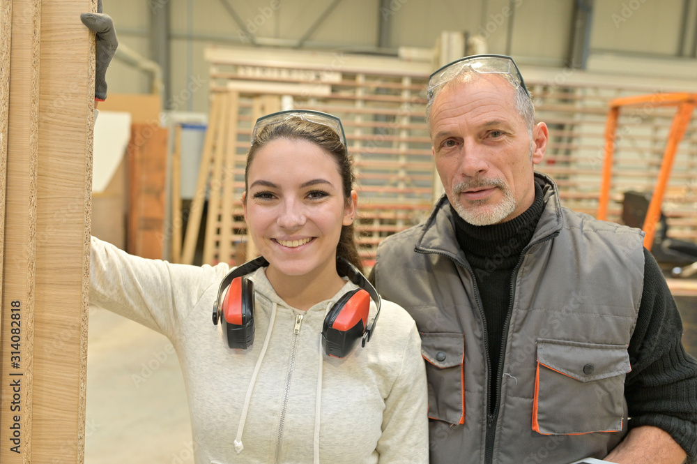 Instructor with apprentice in carpentry warehouse Instructor with apprentice in carpentry warehouse