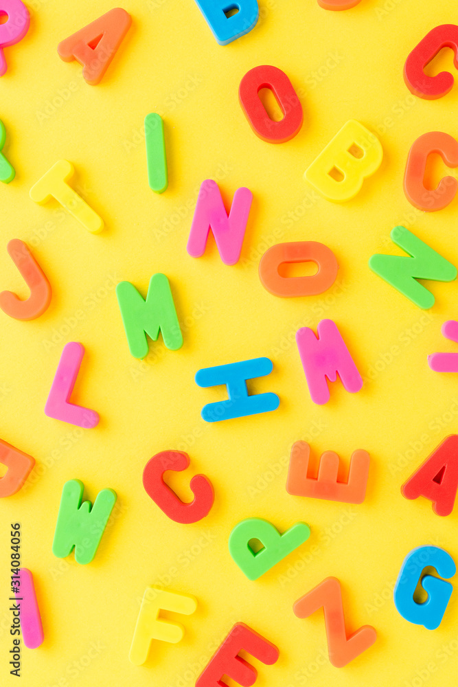 School background with colourful letters on yellow table. Funny pattern School background with colourful letters on yellow table. Funny pattern