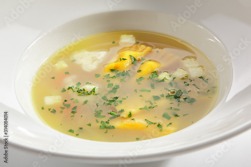 Chicken Bouillon with Tortellini Pasta in White Restaurant Bowl