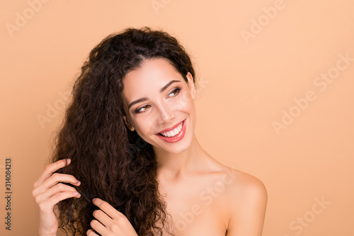 Close-up portrait of her she nice-looking well-groomed attractive gorgeous confident winsome perfect cheerful cheery wavy-haired girl isolated over beige pastel background