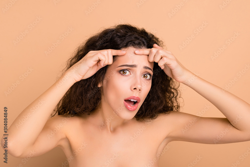 Naklejka premium Close-up portrait of her she nice-looking attractive winsome nervous wavy-haired girl showing forehead teen refreshment medicine isolated on beige pastel background