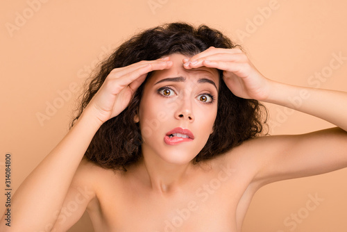 Close-up portrait of her she nice-looking attractive winsome wavy-haired girl showing forehead wrinkles correction medicine solution isolated on beige pastel background