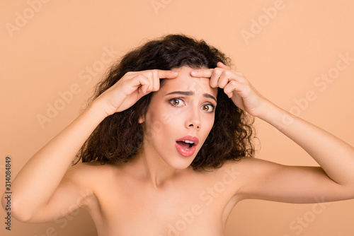 Close-up portrait of her she nice-looking attractive winsome nervous wavy-haired girl showing forehead teen refreshment medicine isolated on beige pastel background