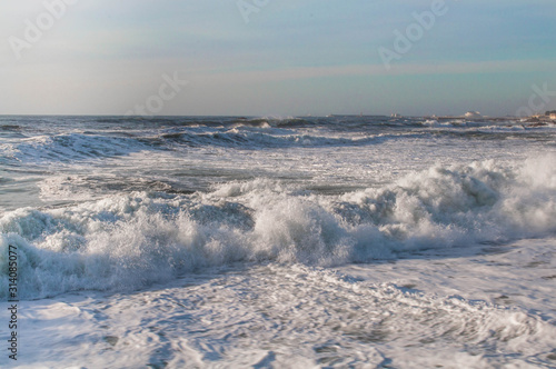 Waves on the oceanfront, foam from powerful waves