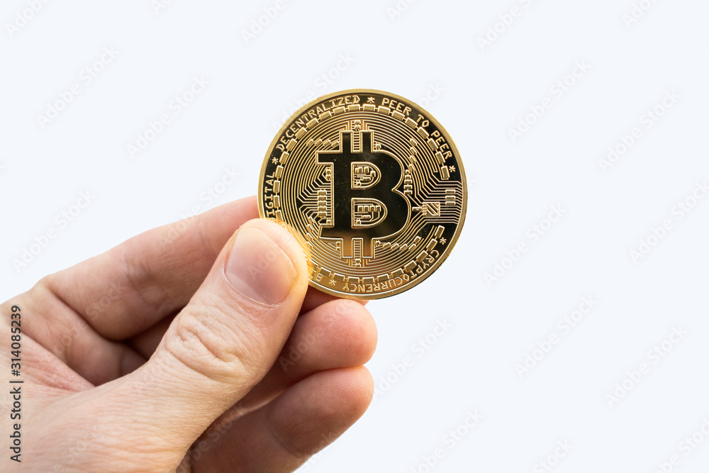 Cryptocurrency holds gold coins in a hand on a white background. Bitcoin Litecoin. Cryptocurrency holds gold coins in a hand on a white background. Bitcoin Litecoin.
