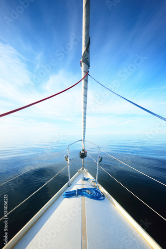 Tableau sur toile White sloop rigged yacht sailing in an open Baltic sea on a clear sunny day