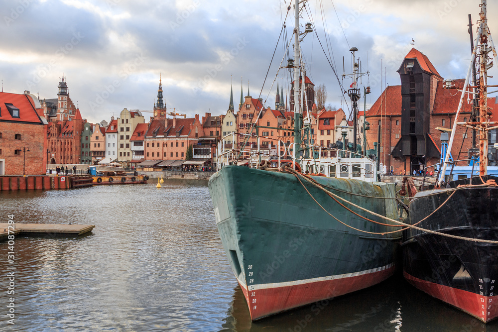Fototapeta premium Gdansk city promenade in poland with beautiful old buildings and ships in winter