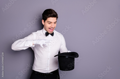 Slika na platnu Portrait of crazy magician hold hand black cylinder hat make spell abracadbra en