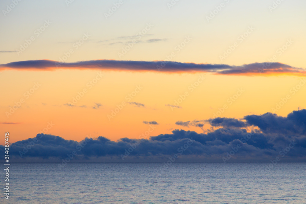Obraz premium Bright cumulus clouds against the blue sky. Sunset sky Natural background. seascape