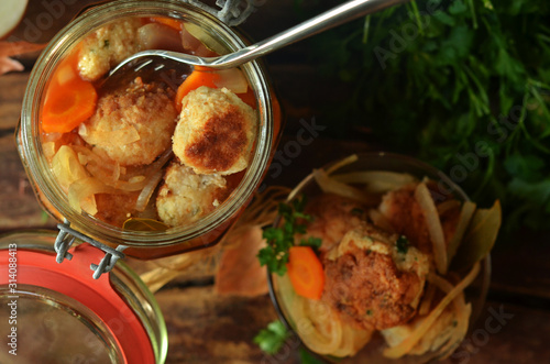 Fish meatballs marinated in a glass jar photo